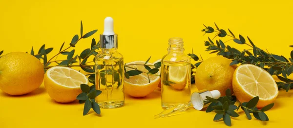 Concept of natural cosmetics with lemon oil on yellow background