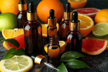 Yağlı damlalar ve siyah dumanlı masada farklı turunçgiller.