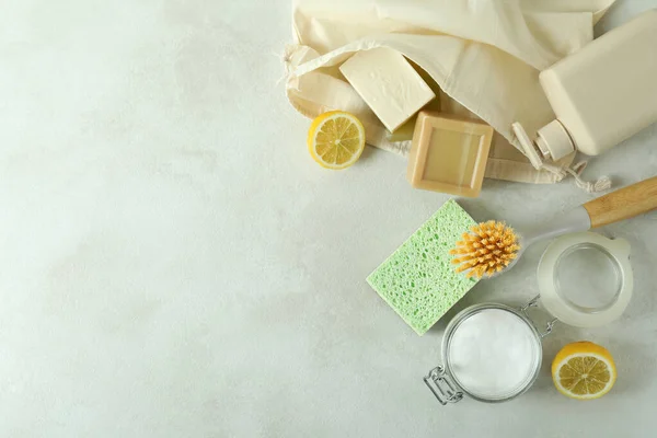 Cleaning concept with eco friendly cleaning tools on white textured table