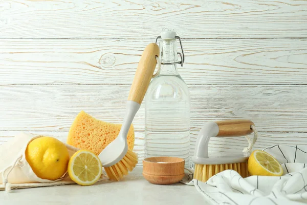 Cleaning concept with eco friendly cleaning tools against wooden background