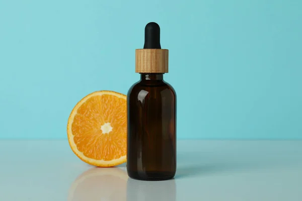 Dropper Bottle Oil Orange Blue Background — Stock Photo, Image