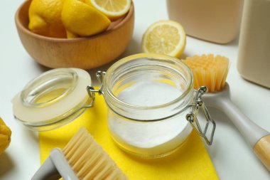 Beyaz arka planda çevre dostu temizlik araçları ve limonları ile temizlik kavramı