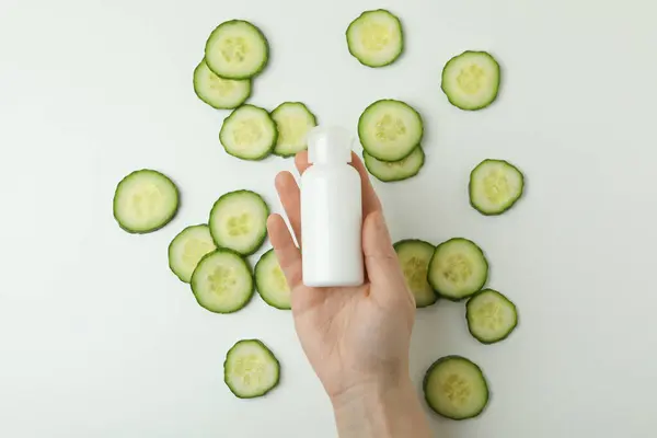 Female Hand Hold Bottle Cosmetics White Background Cucumber Slices — Stock Photo, Image