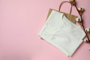 Beyaz kazak, çanta ve pembe arka planda pamuk.