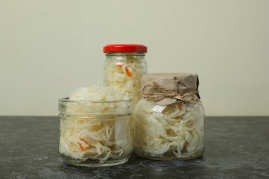 Siyah dumanlı masada cam lahana turşusu kavanozları.