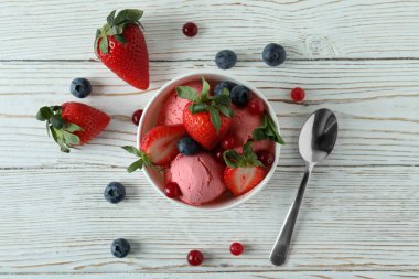 Lezzetli meyveli dondurma beyaz ahşap masada.