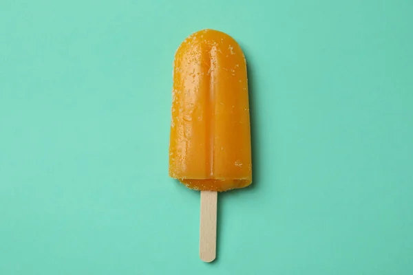 Mango or caramel ice cream stick on mint background
