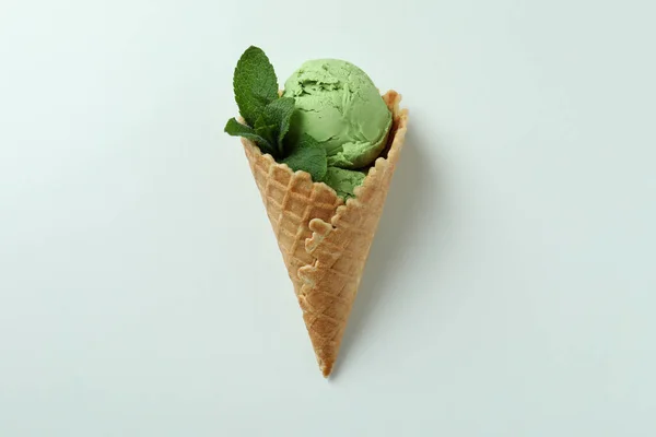 Cone of mint ice cream on white background