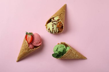 Cones with ice cream on pink background