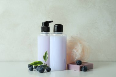 Beyaz desenli arka plana karşı doğal banyo kozmetiği ve yabanmersini.