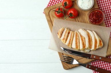 Beyaz ahşap masada ızgara tavukla lezzetli yemek kavramı