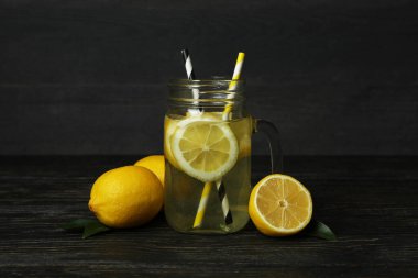 Ahşap arka planda bir kavanoz limonata.
