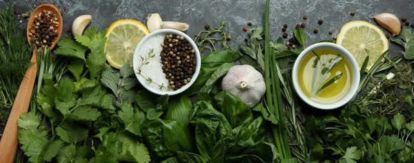 Fresh herbs on black smokey background, top view