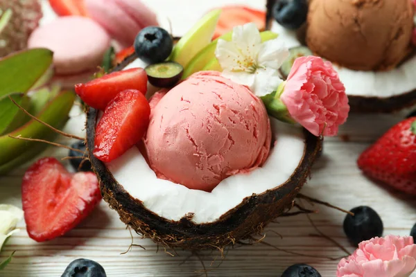 Concept of delicious fruit ice cream on wooden table