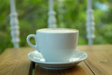 Restorandaki ahşap masada bir fincan kahve.