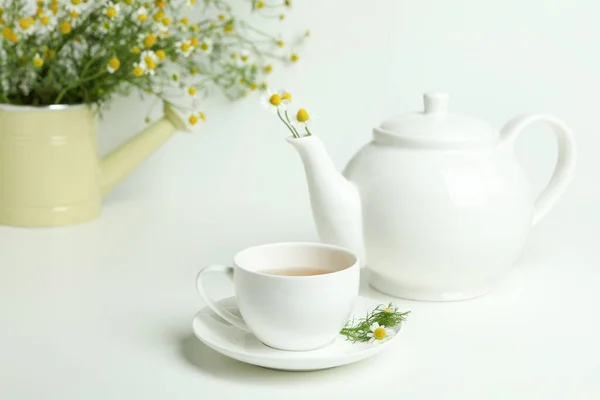 Concept of breakfast with chamomile tea on white table