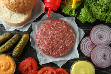 Concept of cooking burger on wooden table