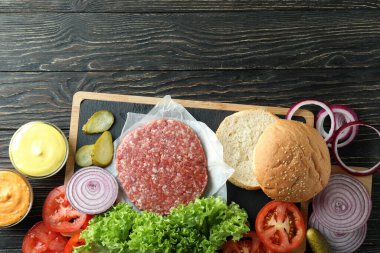 Concept of cooking burger on wooden table