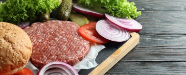 Concept of cooking burger on wooden table