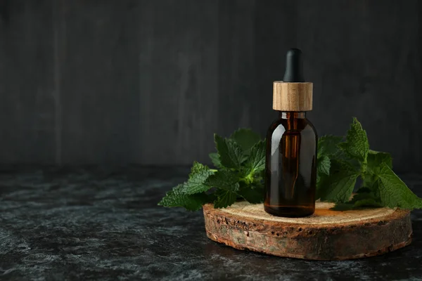 Bottle Nettle Essence Oil Black Smokey Table — Stock Photo, Image