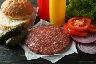 Concept of cooking burger on wooden table