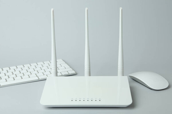 Workplace with Wi - fi router on gray background