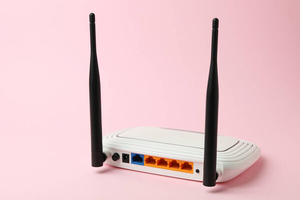 Wi-Fi router with external antennas on pink background