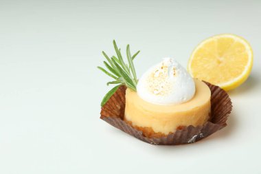 Tasty lemon cupcake on white background, space for text