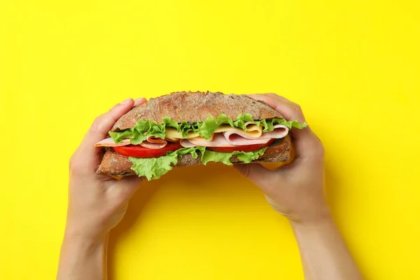 Female Hands Hold Ciabatta Sandwich Yellow Background — Stok fotoğraf