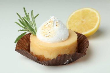 Tasty lemon cupcake on white background, close up