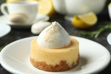 Concept of tasty breakfast with lemon cupcakes and macaroons