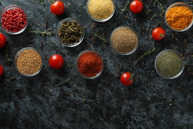 Siyah dumanlı arka planda, kaselerdeki aromatik baharatlar