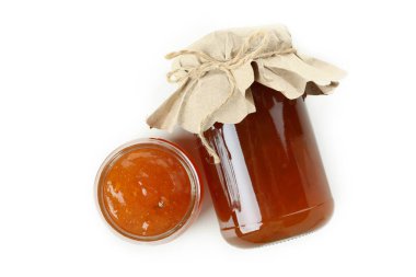 Kavanoz ve bir kase şeftali reçeli.