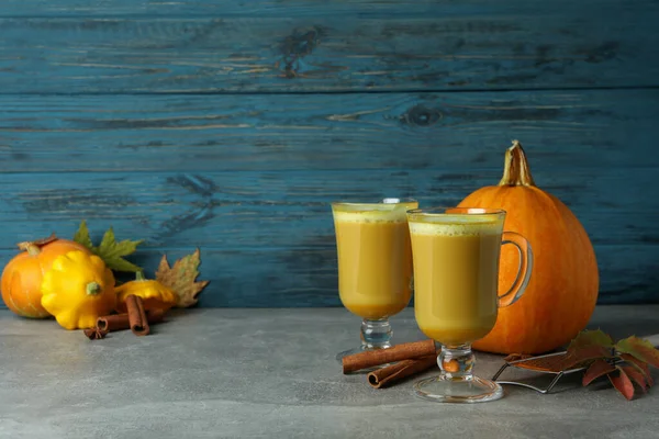 Concept of pumpkin latte against wooden background