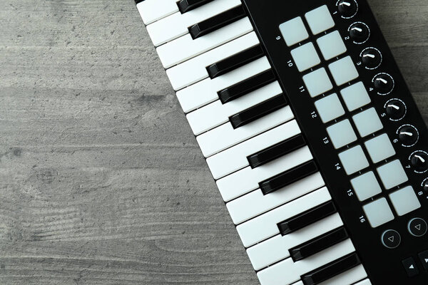 Midi keyboard on gray textured background, space for text