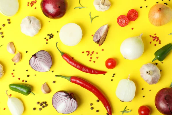 Sarı arka planda farklı baharatlı sebzeler.