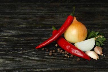 Kırsal ahşap arka planda farklı baharatlı sebzeler.