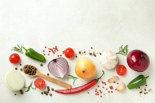 Different spicy vegetables on white textured background