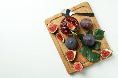 İncir reçelli tahta, malzemeler ve beyaz arka planda kaşık