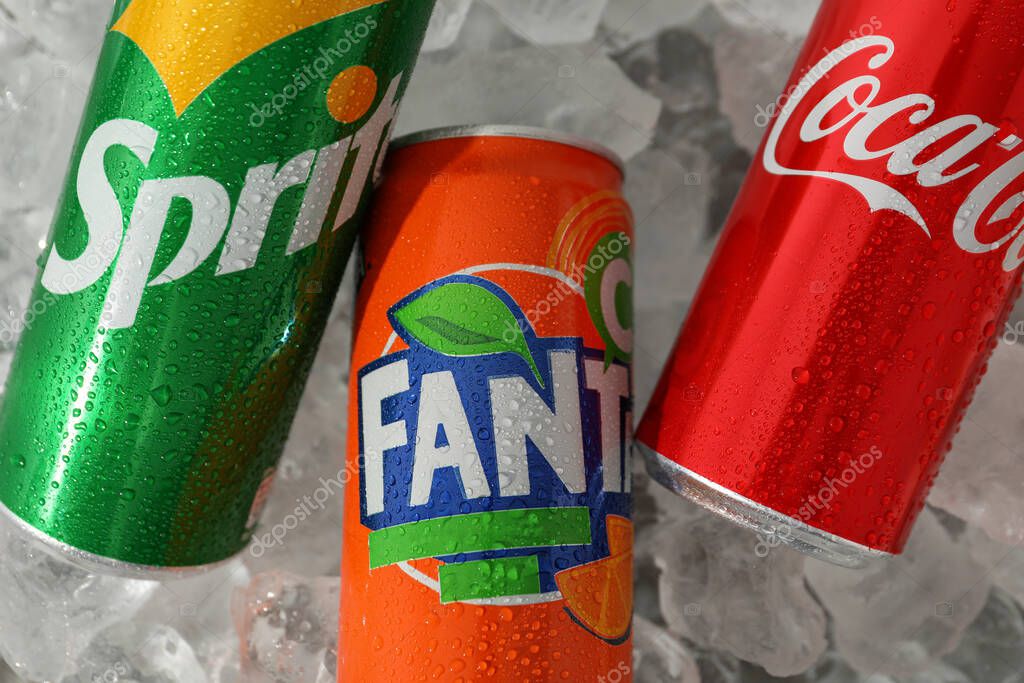 Odessa, Ukraine - September 23, 2021: Coca - Cola, Sprite and Fanta cans on ice.