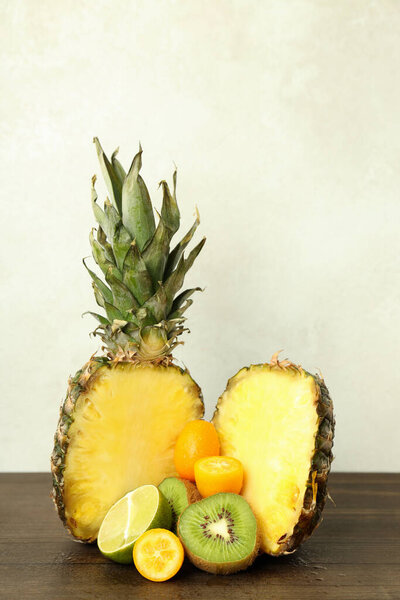 Exotic fruits on wooden table against white background.