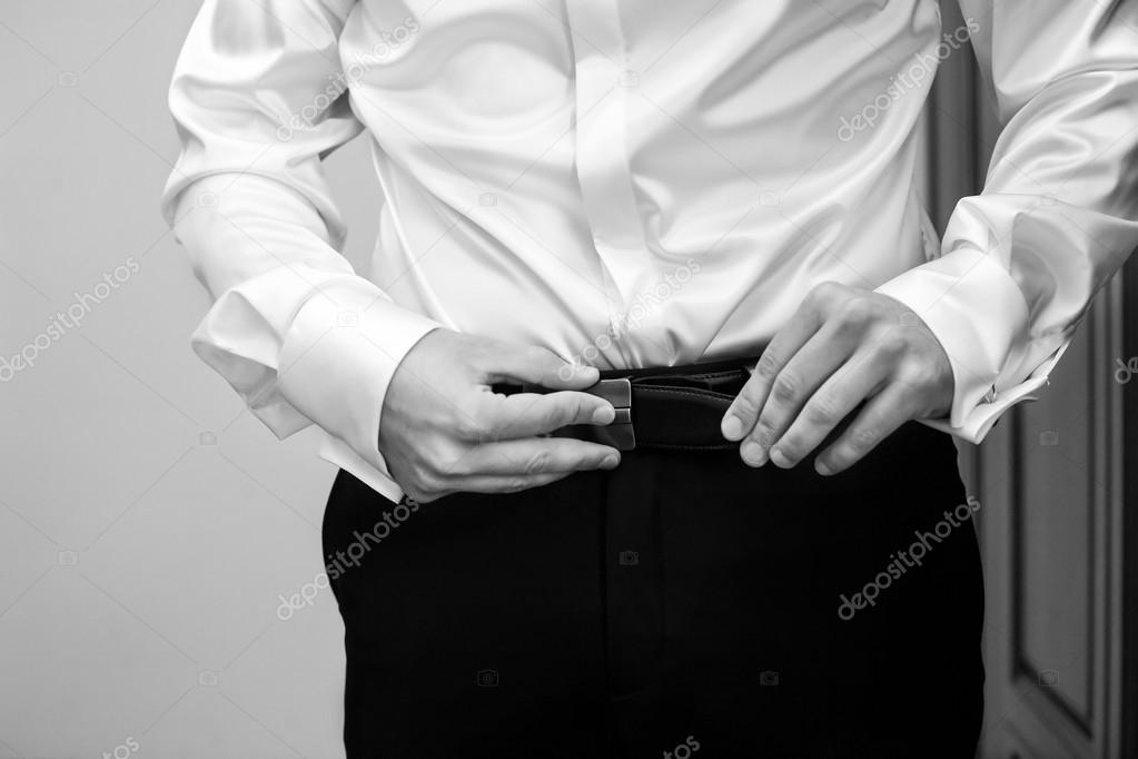 man buttons white shirt