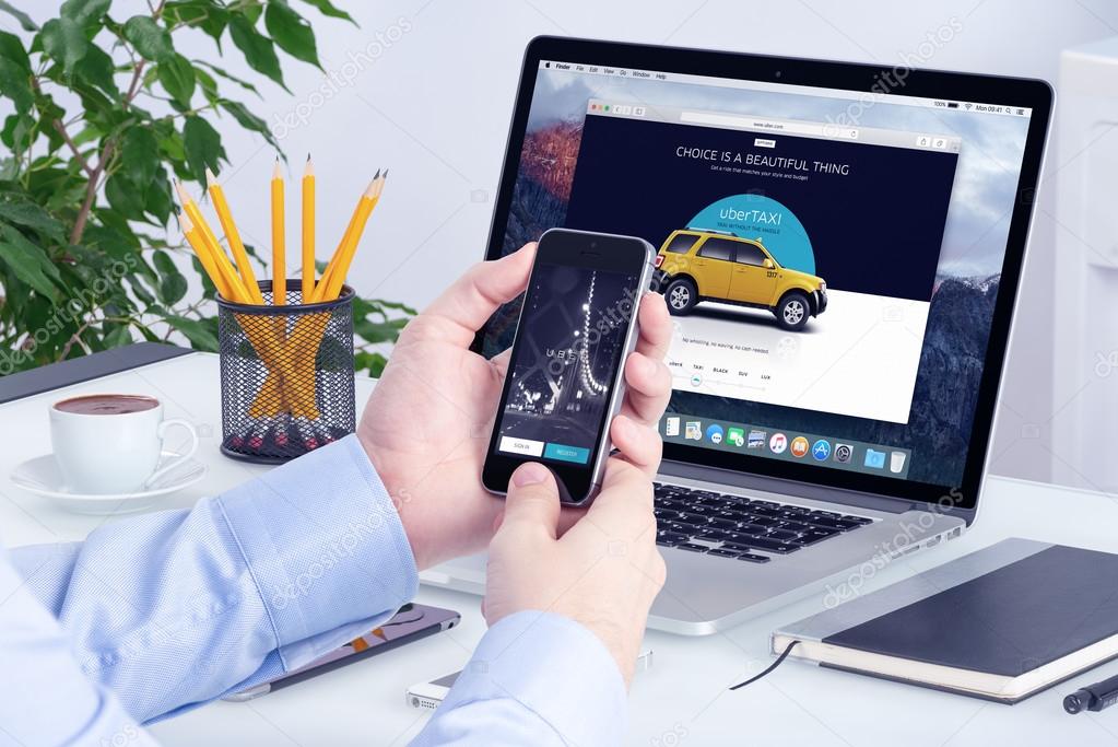 Uber application on the Apple iPhone display and desktop version of Uber on the Apple Macbook Pro screen. Uber multi devices concept. All gadgets in full focus. Varna, Bulgaria - May 29, 2015.