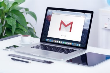 Google Gmail logo on Apple MacBook Pro display on office desk clipart