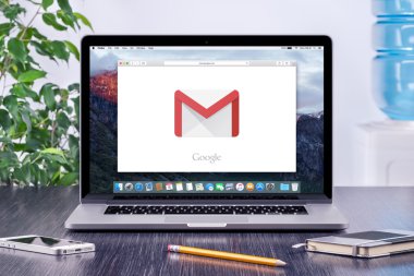 Google Gmail logo on Apple MacBook display in office workplace clipart