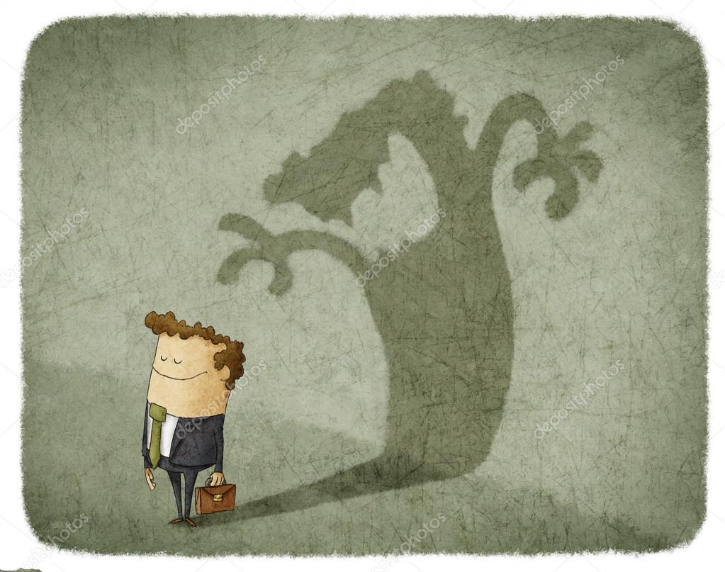 Businessman standing and casting shadow of an angry man