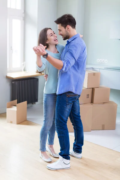 Couple with unpacked boxes in new home