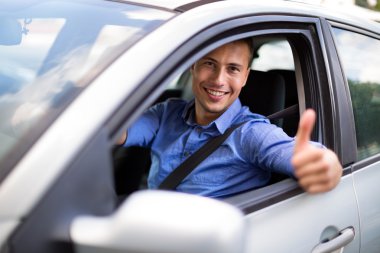 Young man sitting in a car  clipart
