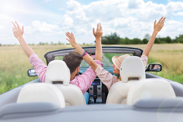 Happy Couple Driving in Convertible