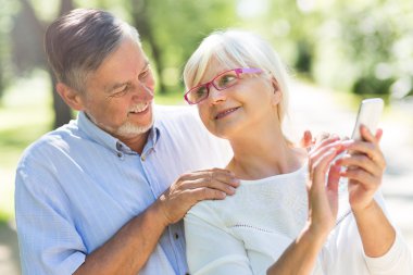 Cep telefonu kullanan yaşlı çift